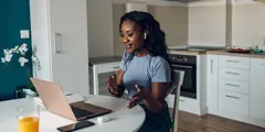 Young Woman On Laptop With Headphones